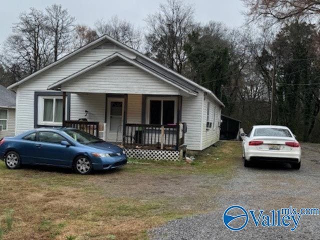 bungalow-style house with a front yard and covered porch