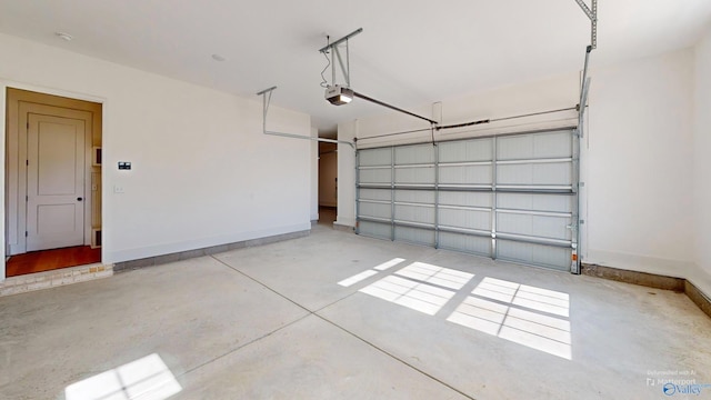 garage with baseboards and a garage door opener