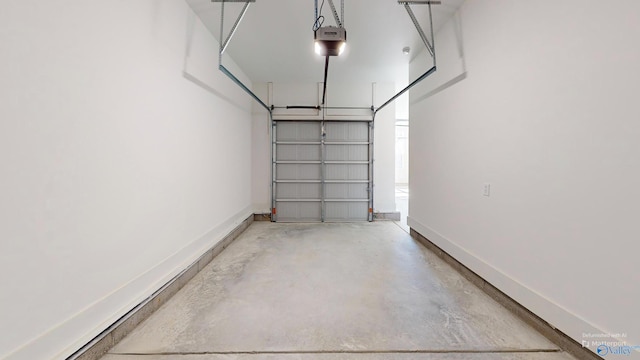 garage with baseboards and a garage door opener
