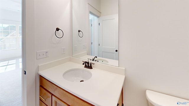 bathroom featuring toilet and vanity