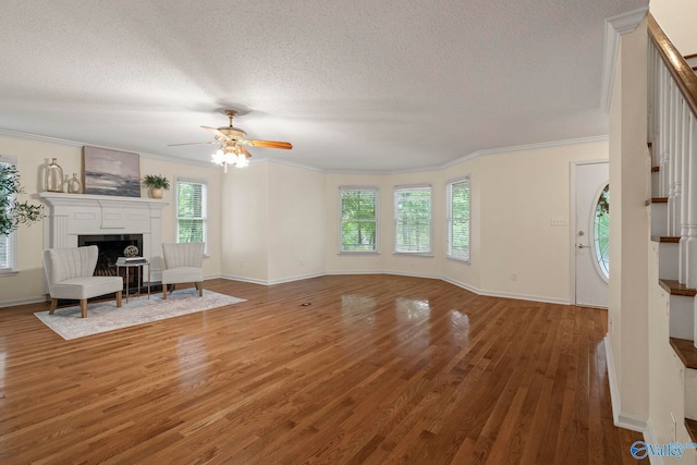 7925 Smoke Rise Rd SE, Huntsville, AL 35802 - unfurnished living room featuring stairway, a textured ceiling, wood finished floors, ornamental molding, and ceiling fan