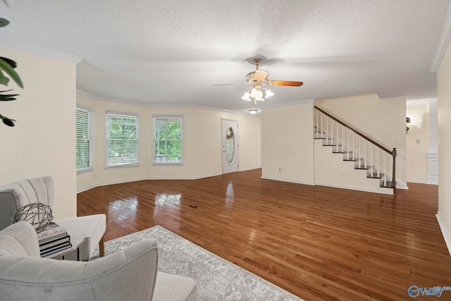7925 Smoke Rise Rd SE, Huntsville, AL 35802 - living room featuring ornamental molding, wood finished floors, stairs, a ceiling fan, and a textured ceiling