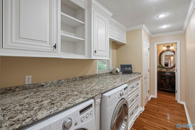 7925 Smoke Rise Rd SE, Huntsville, AL 35802 - laundry room with washer and dryer, a textured ceiling, cabinet space, wood finished floors, and ornamental molding