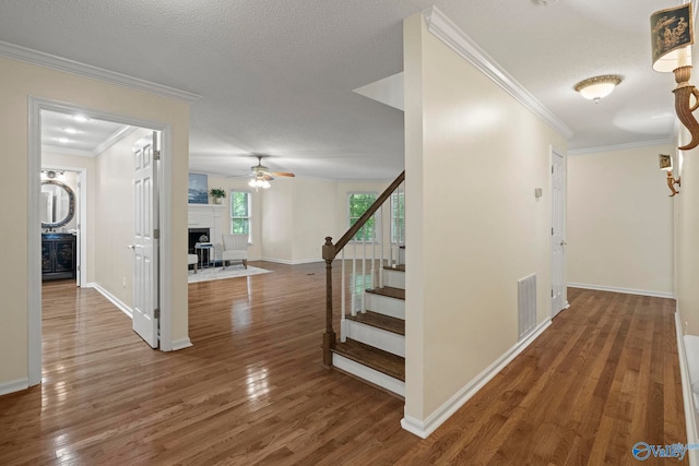 7925 Smoke Rise Rd SE, Huntsville, AL 35802 - hallway featuring stairs, ornamental molding, wood finished floors, and a textured ceiling