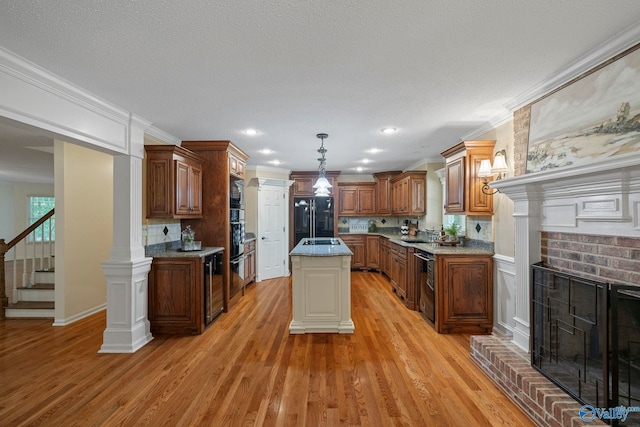 7925 Smoke Rise Rd SE, Huntsville, AL 35802 - kitchen featuring black appliances, a brick fireplace, decorative backsplash, light wood-style floors, and crown molding