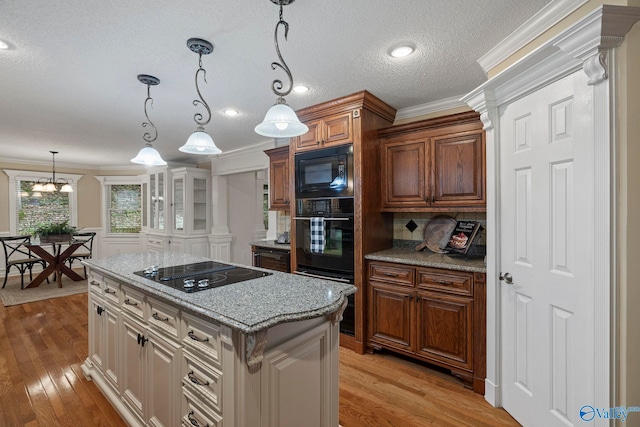 7925 Smoke Rise Rd SE, Huntsville, AL 35802 - kitchen with black appliances, light wood-style flooring, crown molding, hanging light fixtures, and backsplash