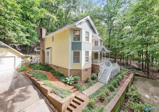 7925 Smoke Rise Rd SE, Huntsville, AL 35802 - victorian house featuring covered porch, stairs, crawl space, a chimney, and concrete driveway