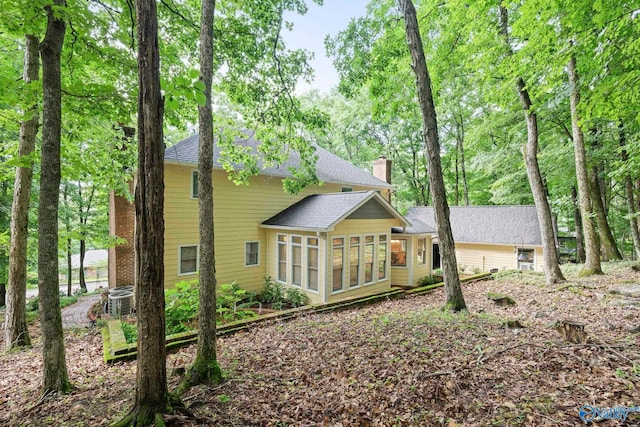 7925 Smoke Rise Rd SE, Huntsville, AL 35802 - rear view of property with a sunroom, a chimney, and a shingled roof