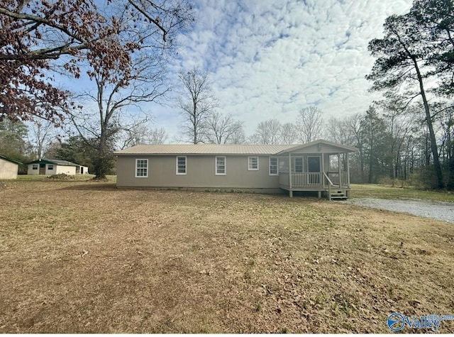 view of front of property with a front yard and covered porch