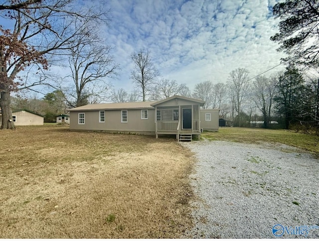 view of front of house with a front yard and covered porch