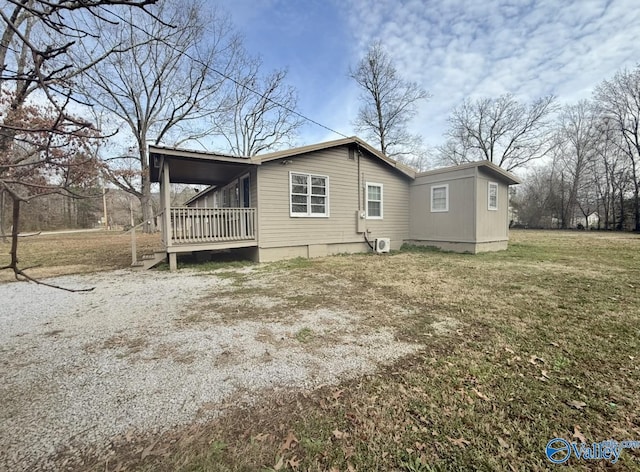 view of home's exterior featuring a porch and a yard