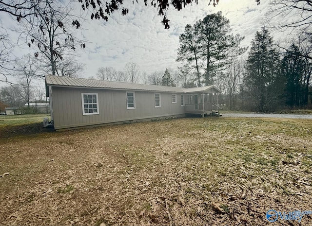 view of side of home featuring a lawn