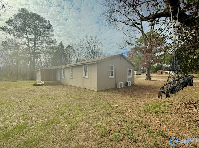 view of side of property with a lawn