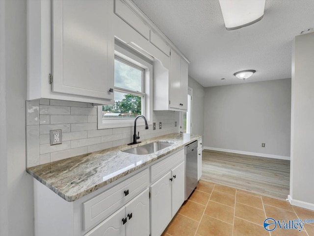 323 Earnhardt Dr, New Market, AL 35761 - kitchen with dishwasher, a sink, baseboards, a textured ceiling, and white cabinets