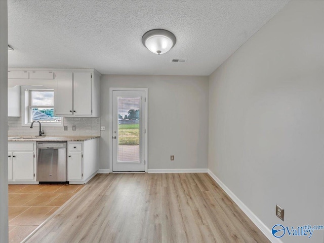 323 Earnhardt Dr, New Market, AL 35761 - kitchen with stainless steel dishwasher, a sink, light countertops, tasteful backsplash, and white cabinets