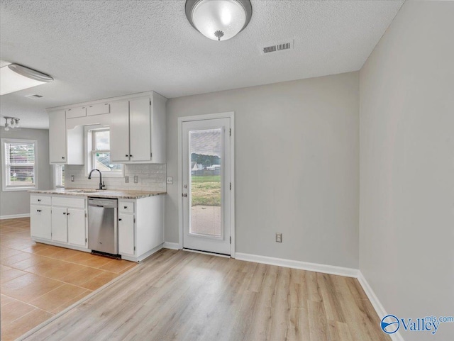 323 Earnhardt Dr, New Market, AL 35761 - kitchen with stainless steel dishwasher, a sink, baseboards, a textured ceiling, and decorative backsplash