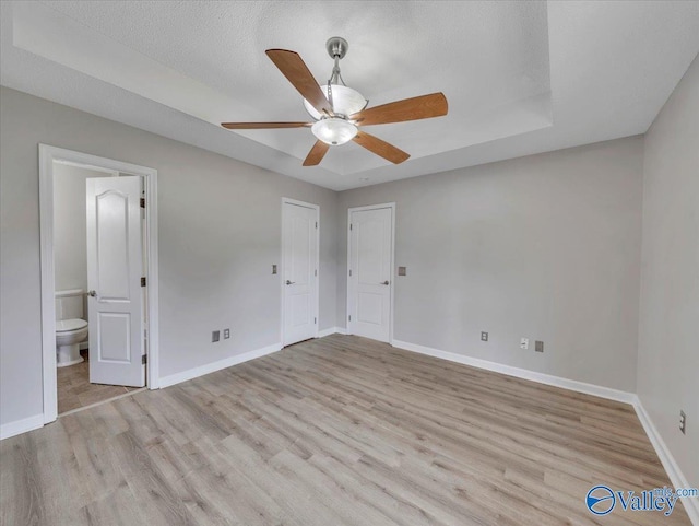 323 Earnhardt Dr, New Market, AL 35761 - unfurnished bedroom with light wood-style flooring, baseboards, ensuite bath, and ceiling fan