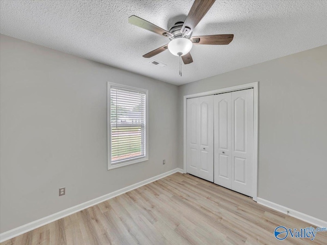 323 Earnhardt Dr, New Market, AL 35761 - unfurnished bedroom featuring light wood-type flooring, a textured ceiling, baseboards, a closet, and ceiling fan