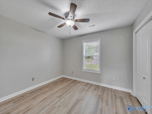 323 Earnhardt Dr, New Market, AL 35761 - spare room with light wood-style flooring, a ceiling fan, a textured ceiling, and baseboards