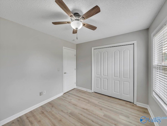 323 Earnhardt Dr, New Market, AL 35761 - unfurnished bedroom featuring light wood finished floors, a textured ceiling, a closet, baseboards, and ceiling fan