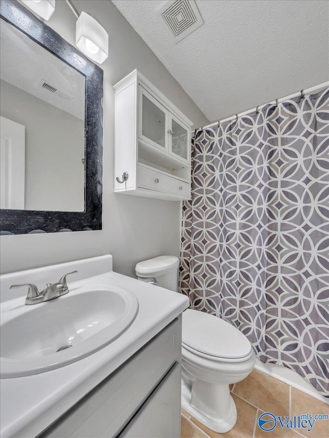 323 Earnhardt Dr, New Market, AL 35761 - bathroom with vanity, toilet, a shower with curtain, a textured ceiling, and tile patterned flooring