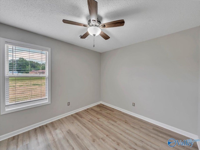 323 Earnhardt Dr, New Market, AL 35761 - spare room featuring light wood-style flooring, baseboards, a ceiling fan, and a textured ceiling