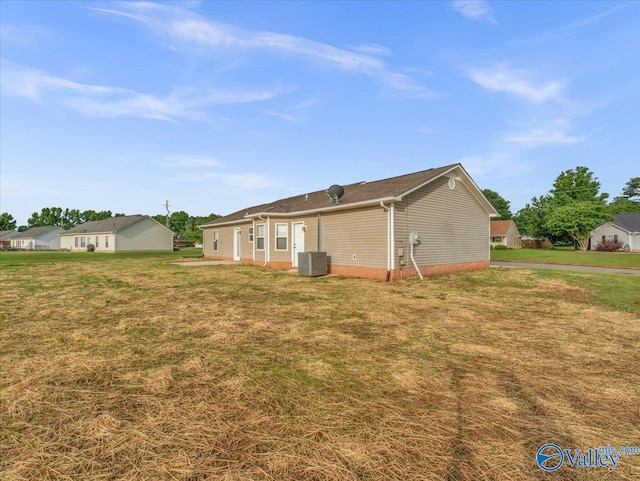 323 Earnhardt Dr, New Market, AL 35761 - back of house with central AC unit and a yard