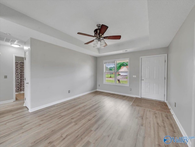 323 Earnhardt Dr, New Market, AL 35761 - empty room featuring light wood-type flooring, a tray ceiling, a ceiling fan, and baseboards