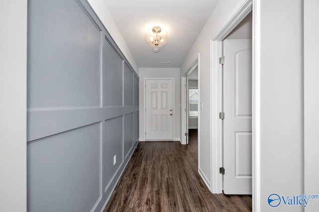 hall with dark wood-type flooring