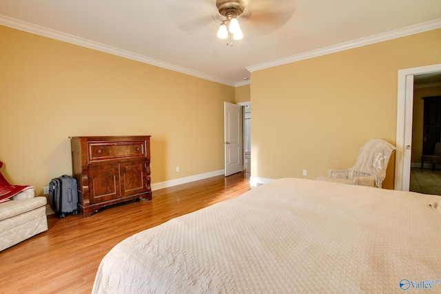 bedroom with ceiling fan, baseboards, wood finished floors, and crown molding