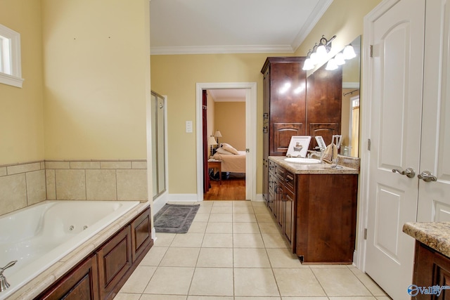 ensuite bathroom featuring ornamental molding, ensuite bath, a tub with jets, tile patterned flooring, and vanity