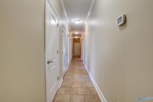 hallway with crown molding and baseboards