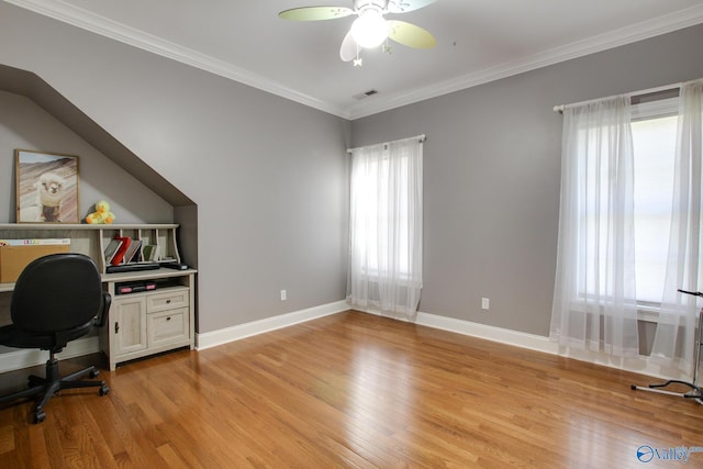 office space with visible vents, crown molding, baseboards, ceiling fan, and light wood-style flooring