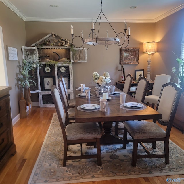 dining area with light wood-type flooring and crown molding