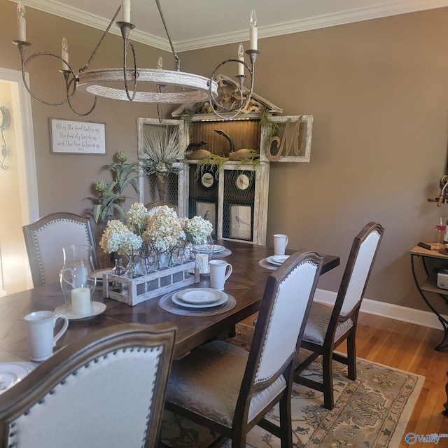 dining room with ornamental molding and hardwood / wood-style flooring