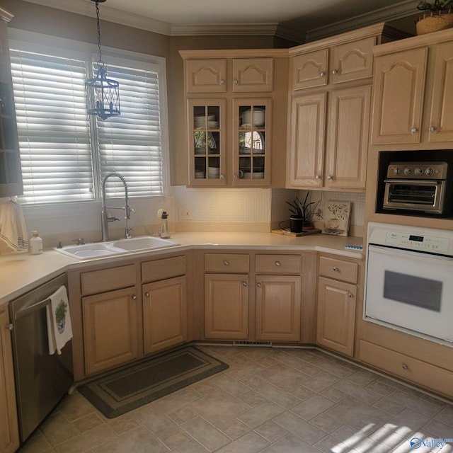 kitchen featuring sink, light brown cabinets, stainless steel dishwasher, oven, and pendant lighting