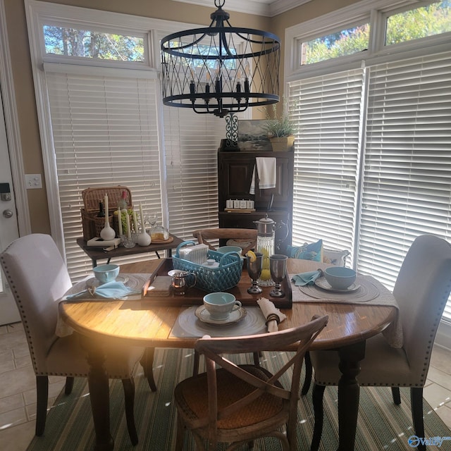 tiled dining room with a wealth of natural light, a chandelier, and ornamental molding