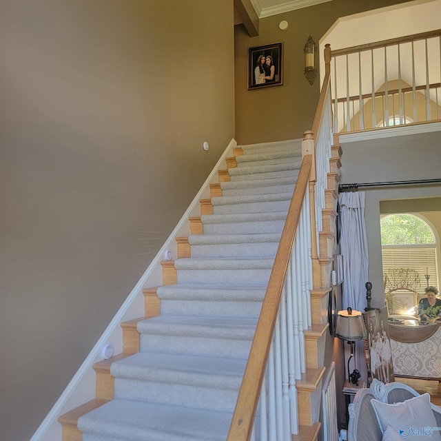 staircase featuring ornamental molding