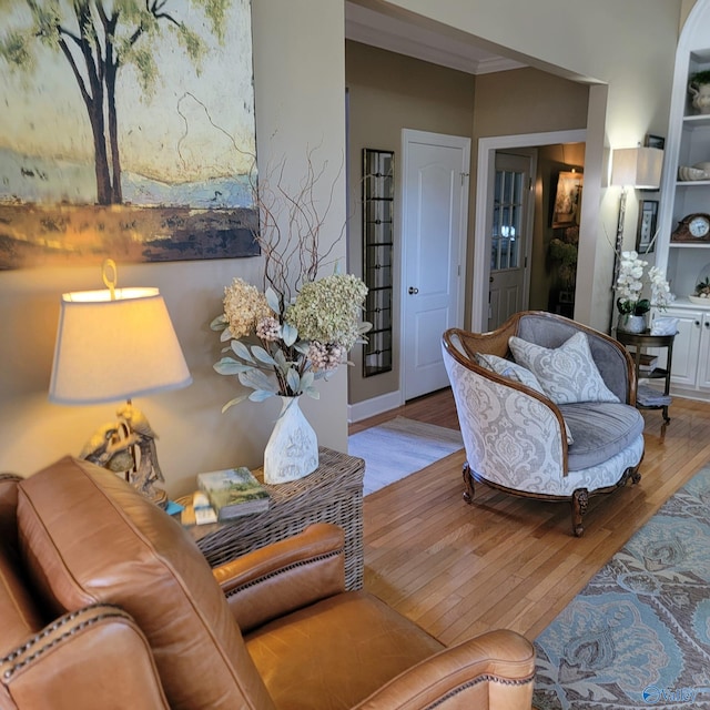 living room with light hardwood / wood-style floors and crown molding