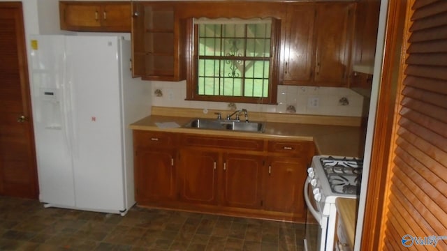 kitchen with white appliances, a sink, light countertops, backsplash, and brown cabinetry