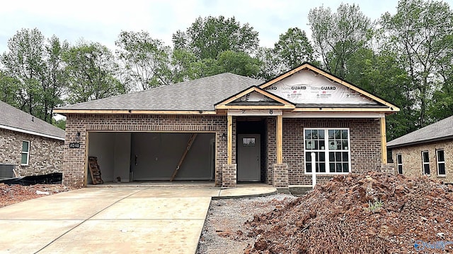 6248 Pisgah Dr NW, Huntsville, AL 35810 - view of front of home featuring driveway, central AC, an attached garage, and brick siding