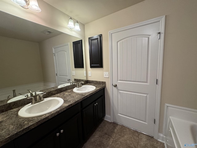 full bathroom with double vanity, visible vents, and a sink