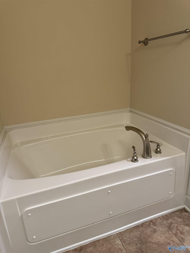 full bath featuring tile patterned floors and a bath