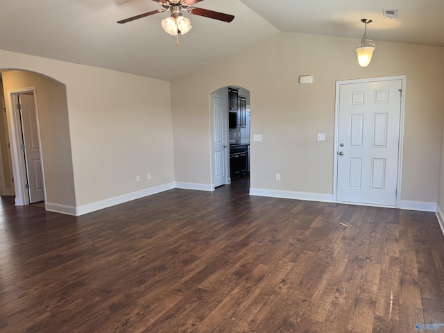 unfurnished living room with a ceiling fan, visible vents, lofted ceiling, arched walkways, and dark wood-style flooring