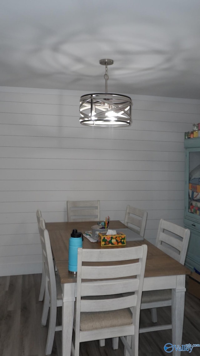 dining space featuring crown molding and wood finished floors