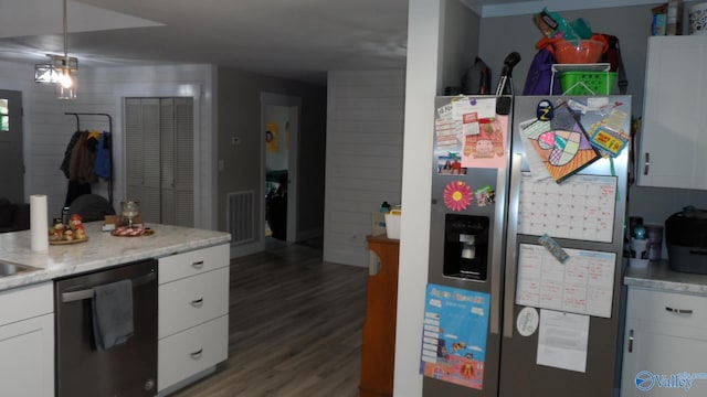 kitchen featuring stainless steel fridge, dishwasher, white cabinets, and light countertops