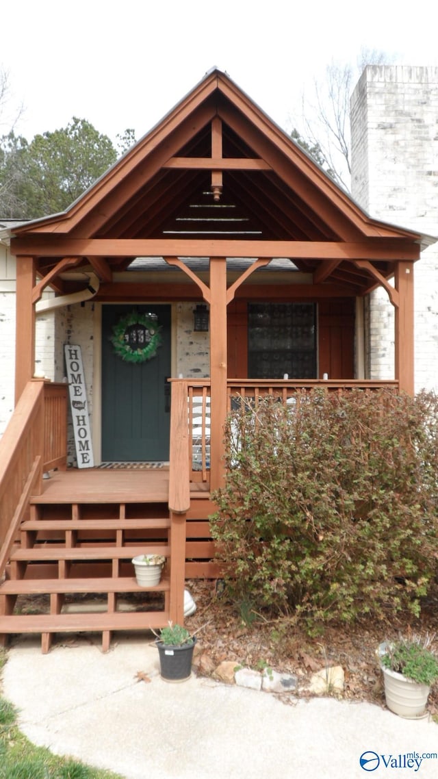 view of exterior entry featuring a porch