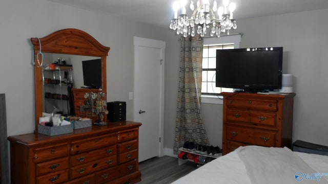 bedroom with a chandelier and wood finished floors