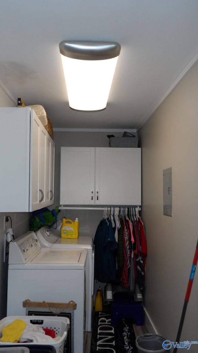 clothes washing area featuring electric panel, cabinet space, and independent washer and dryer