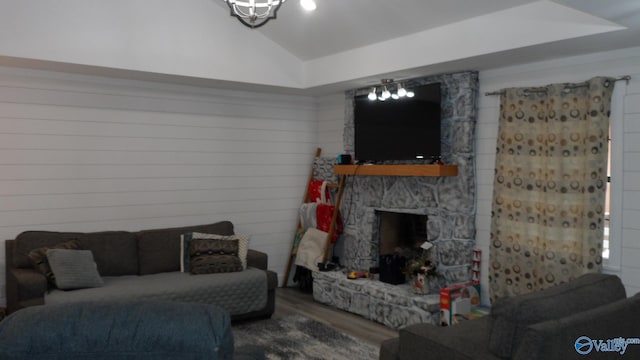 living area with lofted ceiling, wood finished floors, and a fireplace